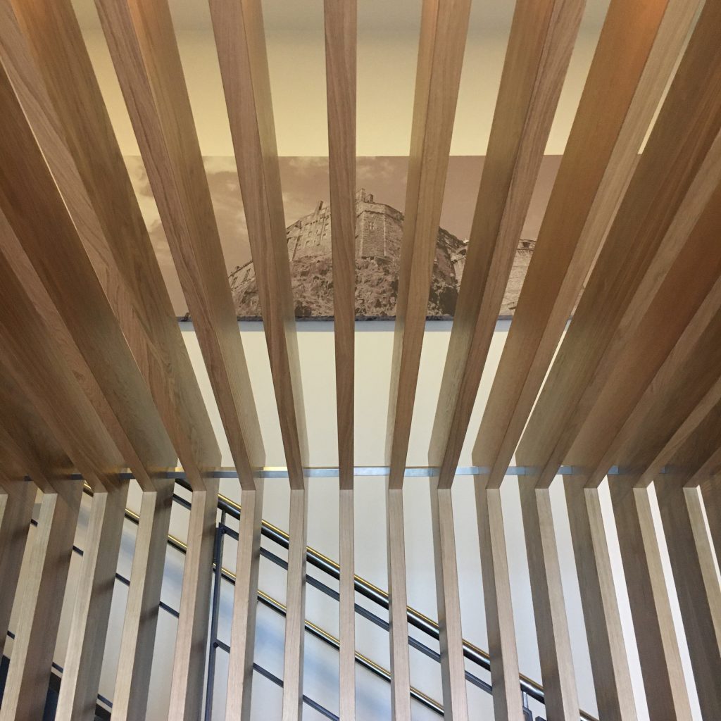 looking through the slatted timber canopy at an image of edinburgh castle